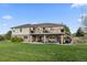 Beautifully landscaped backyard with a large deck, patio, and plenty of green space at 8211 E 128Th Pl, Thornton, CO 80602