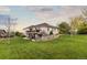 Expansive backyard with white picket fence, mature trees, and elevated back deck and patio at 8211 E 128Th Pl, Thornton, CO 80602