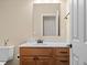 Half bathroom featuring a wooden vanity and toilet at 8211 E 128Th Pl, Thornton, CO 80602