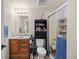 Practical bathroom with wooden vanity, tiled shower, and essential amenities for daily routines at 8211 E 128Th Pl, Thornton, CO 80602