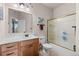 Bright bathroom featuring a glass enclosed shower and wooden vanity at 8211 E 128Th Pl, Thornton, CO 80602