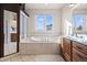 Bathroom with soaking tub, tile floors and double sink vanity at 8211 E 128Th Pl, Thornton, CO 80602