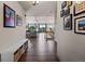 Inviting foyer featuring hardwood floors, vaulted ceiling, and views of the spacious living room at 8211 E 128Th Pl, Thornton, CO 80602