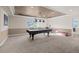 Basement game room with pool table and stylish lighting creates a fun recreational space at 8211 E 128Th Pl, Thornton, CO 80602