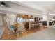 Open-concept kitchen with island, bar seating, and a dining area is perfect for entertaining at 8211 E 128Th Pl, Thornton, CO 80602
