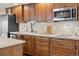 Charming kitchen showcases wooden cabinetry, light countertops, and updated appliances at 8211 E 128Th Pl, Thornton, CO 80602