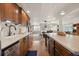 Updated kitchen boasts wood cabinets, stainless steel appliances, and views into the living area at 8211 E 128Th Pl, Thornton, CO 80602