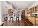 Spacious kitchen with a breakfast bar, wood cabinets, stainless steel appliances, and hardwood floors at 8211 E 128Th Pl, Thornton, CO 80602