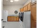 Large laundry room featuring lots of storage space, a sink, and modern washer and dryer units at 8211 E 128Th Pl, Thornton, CO 80602