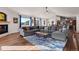 Bright and airy living room with hardwood floors, fireplace, vaulted ceiling, and picture windows at 8211 E 128Th Pl, Thornton, CO 80602