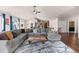 Spacious living room with hardwood floors, vaulted ceiling, and a cozy seating area at 8211 E 128Th Pl, Thornton, CO 80602