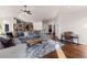 Open concept living room featuring hardwood floors, vaulted ceiling, and plenty of natural light at 8211 E 128Th Pl, Thornton, CO 80602