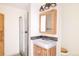 Clean bathroom with wood vanity, large mirror, and a shower stall at 69 Aspen Dr, Golden, CO 80403