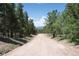 Long dirt road leading to homes with mountain views at 69 Aspen Dr, Golden, CO 80403