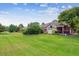 Spacious backyard featuring a well-manicured lawn and a back deck at 3413 Boxelder Dr, Longmont, CO 80503