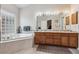 Bright bathroom with soaking tub, dual sinks, and tile floor at 3413 Boxelder Dr, Longmont, CO 80503