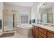Bright bathroom with soaking tub, shower, and dual sinks at 3413 Boxelder Dr, Longmont, CO 80503