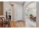 Inviting foyer with hardwood floors, arched doorway leading to the dining room, and view into an adjacent office at 3413 Boxelder Dr, Longmont, CO 80503
