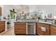 Well-maintained kitchen features wooden cabinets, tile backsplash, and stainless steel dishwasher at 3413 Boxelder Dr, Longmont, CO 80503