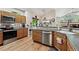Functional kitchen design featuring hardwood floors, stainless steel appliances, and an adjacent dining space at 3413 Boxelder Dr, Longmont, CO 80503