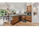 Open-concept kitchen area showcasing hardwood flooring, stainless steel dishwasher, and easy access to adjacent living area at 3413 Boxelder Dr, Longmont, CO 80503