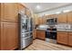 Bright kitchen featuring stainless steel appliances, wooden cabinetry and floors at 3413 Boxelder Dr, Longmont, CO 80503