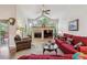 Inviting living room with vaulted ceilings, a fireplace, and large windows for natural light at 3413 Boxelder Dr, Longmont, CO 80503