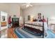 Bright bedroom featuring hardwood floors and access to a bathroom at 3413 Boxelder Dr, Longmont, CO 80503