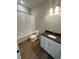 Clean bathroom with a shower-tub combo, sleek vanity, and modern finishes at 251 Washington St, Erie, CO 80516