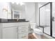 Bathroom featuring a glass enclosed shower, a floating vanity, and modern fixtures at 251 Washington St, Erie, CO 80516