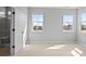 Bright bedroom featuring large windows and adjacent bathroom with modern design at 251 Washington St, Erie, CO 80516