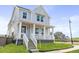 Beautiful two-story home featuring a classic covered porch and a lush green lawn at 251 Washington St, Erie, CO 80516