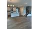 Open-concept kitchen with island, stainless steel appliances, stylish lighting, and modern finishes at 251 Washington St, Erie, CO 80516