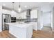Modern kitchen boasting stainless steel appliances, quartz countertops, and a stylish backsplash at 251 Washington St, Erie, CO 80516