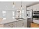 Island with stainless steel dishwasher and sink in modern kitchen with stainless steel appliances at 251 Washington St, Erie, CO 80516