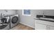 Well-equipped laundry room with modern washer and dryer, plus a sink and window view at 251 Washington St, Erie, CO 80516