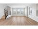Bright and airy living room featuring wood floors, staircase, and many windows at 251 Washington St, Erie, CO 80516