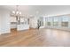 Open-concept living space with wood floors, abundant natural light, and a stylish chandelier at 251 Washington St, Erie, CO 80516