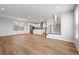 Large living room seamlessly flows into the kitchen, featuring wood floors and modern finishes at 251 Washington St, Erie, CO 80516