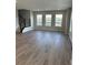 Bright living room featuring hardwood floors, ample natural light, and modern staircase with metal railings at 251 Washington St, Erie, CO 80516