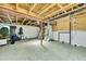 Unfinished basement with concrete floor, exposed wood beams, and utility equipment at 9270 107Th E Pl, Commerce City, CO 80640