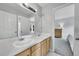 Bathroom with dual sinks, large mirror, and neutral tones offers modern elegance at 9270 107Th E Pl, Commerce City, CO 80640