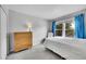 A bright bedroom features a dresser, bed, and large windows providing plenty of natural light at 9270 107Th E Pl, Commerce City, CO 80640