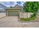 Home with a two car garage, white fence, rock landscaping and green lawn at 9270 107Th E Pl, Commerce City, CO 80640