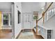 Bright foyer with hardwood floors, staircase, and decorative glass front door at 9270 107Th E Pl, Commerce City, CO 80640
