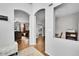 Hallway with hardwood floors and multiple archways lead to living areas at 9270 107Th E Pl, Commerce City, CO 80640