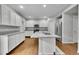 Spacious kitchen with white cabinets, island sink, and stainless steel appliances at 9270 107Th E Pl, Commerce City, CO 80640