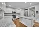 Clean kitchen featuring white cabinets, granite countertops and stainless appliances at 9270 107Th E Pl, Commerce City, CO 80640