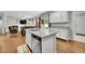 Open concept kitchen and living room area with hardwood floors and modern appliances at 9270 107Th E Pl, Commerce City, CO 80640