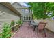 The home features a brick patio with dining set, plants and a white fence at 9270 107Th E Pl, Commerce City, CO 80640